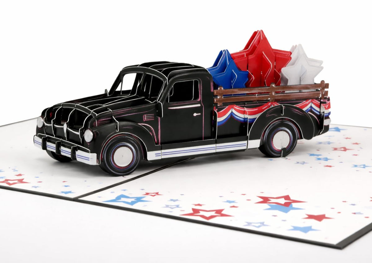 Close-up of black classic truck pop-up with patriotic bunting and layered red, white and blue stars