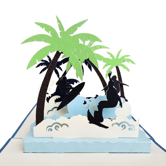 Close view of 3D surfing pop-up card with surfer silhouettes, waves and palm trees