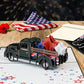 Patriotic classic truck 3D pop-up card with red, white and blue stars displayed beside an envelope and American flag