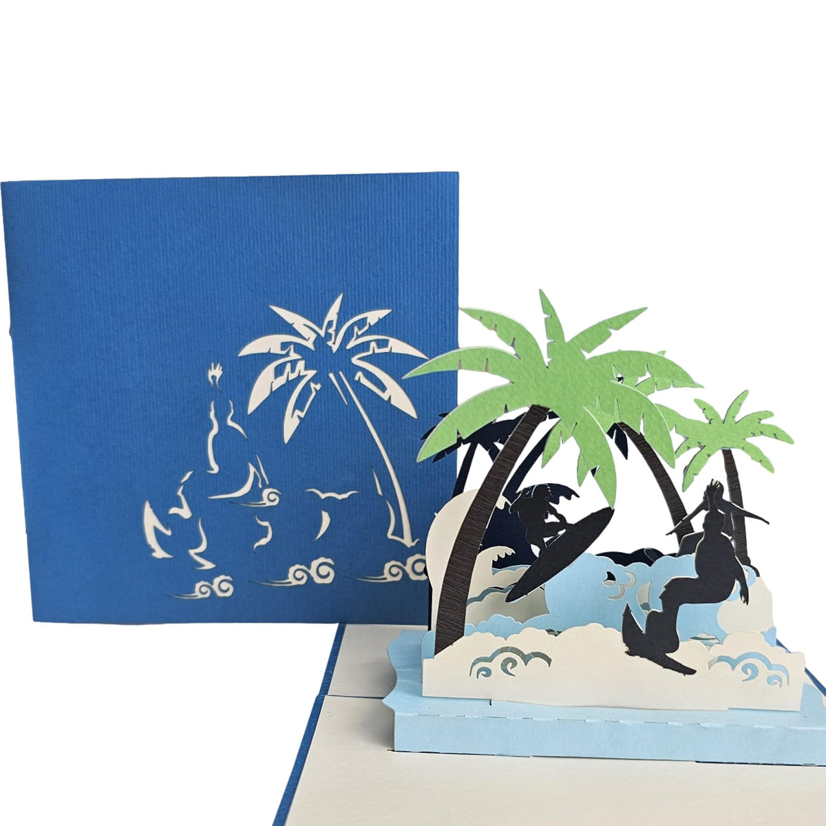 Blue laser-cut surfing card cover beside the open tropical 3D beach scene
